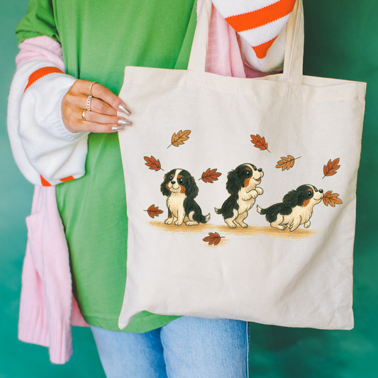 Tricolor Cavalier Chasing Leaves Tote Bag Natural 15" x 16"