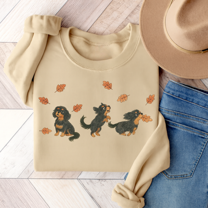 Black Tan Cavalier Chasing Leaves Sweatshirt Sand
